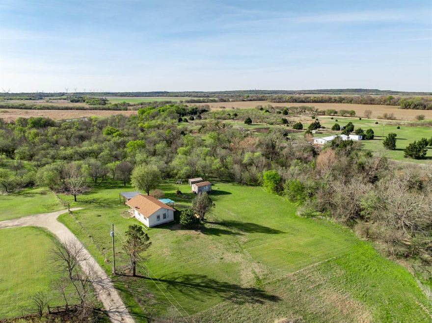 Nestled just outside the city limits, this 3-bedroom, 1-bathroom home offers nearly 12 acres of freedom and privacy. Located off a paved road down a long driveway, this property is perfect for those seeking peace and space without being too far from the highway. Catch a breeze and a rural view of scattered trees and green clearings from your porch. Picture a life away from the city full of gardening, homesteading, hunting, and raising animals on almost 12 acres of land with a creek. It’s not often you find this kind of land with a home at such a reasonable price! If you're looking for a slice of country living with a touch of rustic charm, this could be your perfect spot.