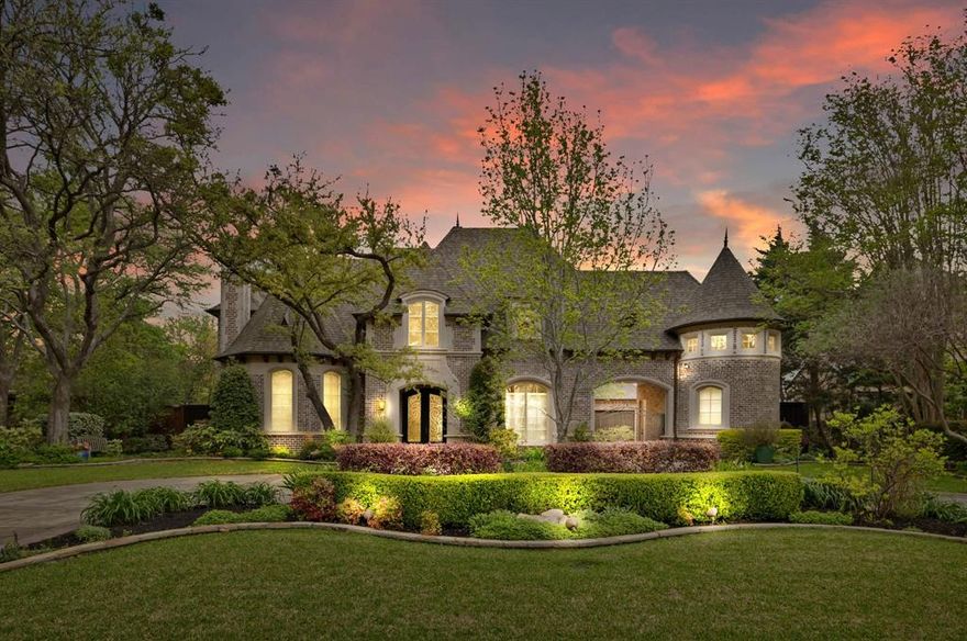 At the crossroads of luxurious living and unbeatable location, this Preston Hollow traditional on a rare .43-acre lot delivers an exceptional lifestyle both inside and out, beginning with a grand entry, dramatic staircase, and rich hardwood floors that set the tone for timeless elegance and craftsmanship. Designed for both everyday family living and elevated entertaining, the home offers expansive spaces including three living areas, two dining areas, and a private office with built-ins and a fireplace. The chef’s kitchen serves as the heart of the home with Viking appliances, a built-in refrigerator, gas cooktop, double ovens, and an oversized island with breakfast bar, complemented by a butler’s pantry, walk-in pantry, and a fully equipped wet bar with ice maker with a wine cooler, while the 800-bottle wine cellar and dedicated media room elevate the entertainment experience. The first-floor primary suite is a private retreat with a sitting area and fireplace, dual bathrooms with heated floors, a jetted tub, a body spray shower, and two custom walk-in closets. Upstairs, each secondary bedroom includes an ensuite bath and walk-in closet, along with flexible living spaces such as an in-home gym and additional office options, plus three spacious attic areas for exceptional storage. Outdoors, a true backyard oasis awaits, featuring a resort-style pool and spa with a swim jet, water and fire features, covered patios, a built-in grill, and lush, seasonally curated landscaping designed for year-round beauty, enhanced by landscape lighting and privacy fencing. Additional highlights include multiple fireplaces throughout, a 3-car garage with EV charging, circular drive, gated entry, and modern connectivity, including fiber internet, all ideally located in the heart of Preston Hollow with convenient access to the Dallas North Tollway, Preston Center, Preston Royal, and NorthPark, offering a rare combination of privacy, sophistication, and convenience.