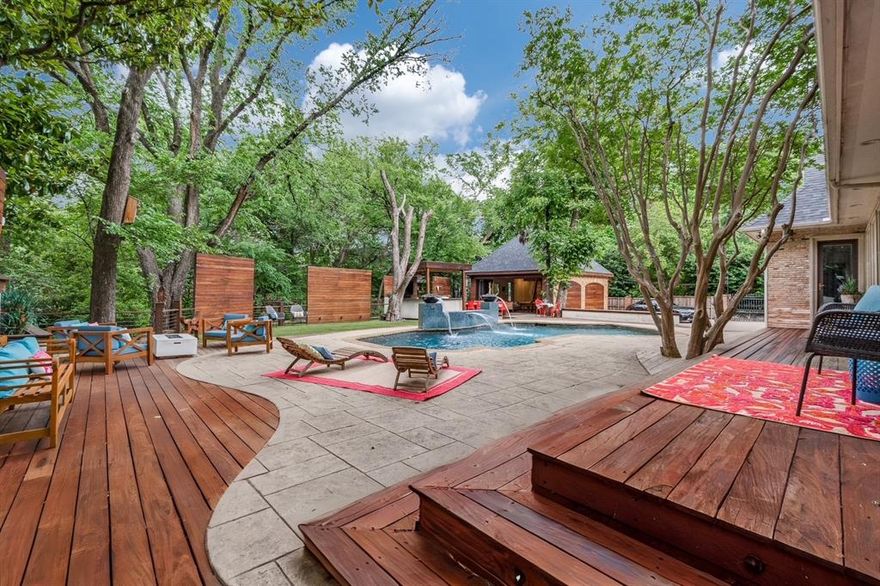 Expansive creek lot offers indoor-outdoor living w optimal privacy for the discerning homeowner. Designer-owned home combines sophistication & warmth w open spaces. Cantilevered deck is perched above creek, canopied by trees. Modern guest house & outdoor spaces offer rare, secluded lot w basketball court, outdoor kitchen, pool & deck areas. Resort-like family living w water features & firepits. Elegant formals w dining, living room, music room, & office w built-in wine storage. Skylit 2-story foyer opens to spacious light-filled den area. Premium kitchen w granite & marble, state-of-the-art appliances, custom cabinetry. Designer lighting by Swarovski, Currey & Co,& Murano Sputnik w bespoke hardware by Joseph Giles & Sherle Wagner. Waterstone plumbing integrates beauty & function into custom millwork & hand-forged Brazilian hardwoods. First-floor master suite w sitting room & office. Spa bath w Brizo plumbing fixtures, hand-carved Italian marble, Walker Zanger tile, curated lighting & mirrors, free-standing soaker tub. Four add’l bedrooms & baths w spacious upstairs den & game room w built-ins, arched nooks, & custom window treatments. Soaring 10-ft ceilings accentuate light-filled casement windows & French doors. Backyard oasis features pool & waterfall w Ipe Brazilian Hardwood deck, fully equipped outdoor kitchen, bar, & alfresco dining for 12—extending to spacious guesthouse w 20-foot accordion glass doors & game room w sleepover loft, indoor kitchen, bath, steam room, sauna. Indoor-outdoor living space w pool & ping pong table opening to bifold doors to private sports training w unobstructed views of tree-lined creek. Integrated surround sound & floating balcony extend over creek to observation deck. Meticulous attention to detail blends timeless style w clean-lined sophistication, offering unparalleled privacy in coveted Preston Hollow neighborhood. Situated near area’s top private schools, this Strait Lane offering sits on Dallas’ most iconic street.