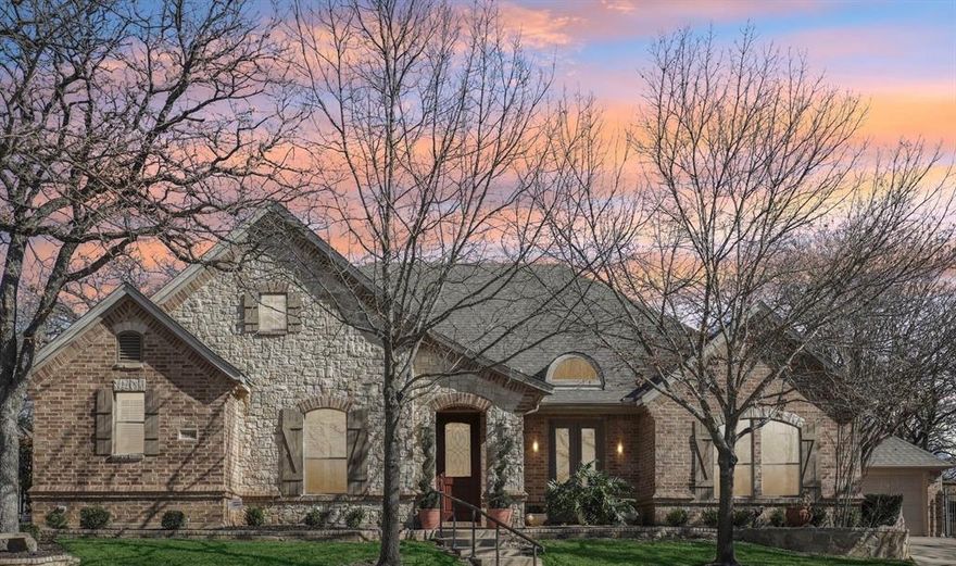 WITH OVER $100,000 IN UPGRADES, This spectacular single story custom home is located in a quiet Birdville ISD neighborhood. The beautifully appointed residence features new hand scraped hardwood floors, 10 foot ceilings with crown molding, and plantation shutters throughout. The open concept design allows the chef’s kitchen complete with an island, two sinks, a wine refrigerator, and a custom built in breakfast nook to flow seamlessly into the living and dining areas. The spacious living room showcases a stunning stone fireplace complete with gas logs and custom built in cabinetry. The split bedroom layout offers privacy, while a media room sits adjacent to a home office featuring custom built in cabinets. An oversized laundry room leads to an extra deep two car garage, providing excellent storage and functionality. Outside, you can enjoy two covered patios overlooking a professionally landscaped, low maintenance backyard highlighted by a beautiful rock waterfall.