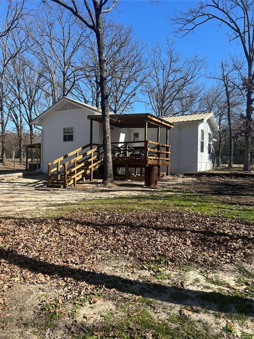 Peaceful country living just minutes from Lake Fork! Tucked away on a beautiful 1-acre tract, this inviting 2 bedroom, 2 bath home offers the perfect blend of privacy, comfort, and convenience. Surrounded by mature trees and nature, enjoy relaxing peek-a-boo views of Lake Fork while still being close to shopping, dining, and everyday necessities.
The home features welcoming covered porches ideal for morning coffee or evening sunsets, along with multiple outbuildings that provide excellent storage, workshop space, or room for lake toys and hobbies. A carport adds covered parking, and the spacious lot offers plenty of room to garden, entertain, or simply enjoy the quiet East Texas setting.
Inside, the home offers a comfortable layout with an open living and dining area, a functional kitchen, and generously sized bedrooms. Whether you’re looking for a full-time residence, a weekend lake retreat, or a low-maintenance retirement property, this home checks all the boxes.
Located outside city limits, this property provides flexibility and freedom rarely found so close to town. A wonderful opportunity for first-time home buyers, retirees, or anyone seeking a peaceful lifestyle near one of East Texas’ most popular lakes.