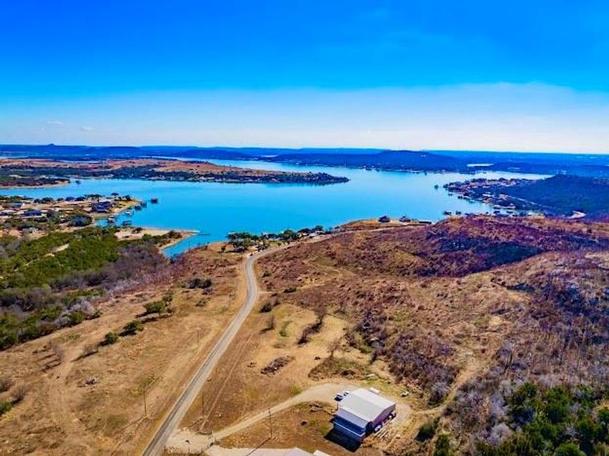 RARE OPPORTUNITY TO BUY, 3.2 ACRES on the WESTSIDE OF PK, with a 2000SQFT CLIMATE CONTROLLED, FOAM INSULATED SHOP, 756SQFT RV CARPORT AND 320SQ CONTAINER, all with Multiple LAKE HOME BUILD SITES below and up the Hill with Stunning, Panoramic PK Lake, Sunrise and Sunset Views. Plus the Shop itself could be used as a Barndo as well, all you need is a Septic System and a Bathroom. PK Metered Water is already at the Building, and Electric for the HVAC System, & Electrical. The Property is currently being Offered with the Owner's Waterfront Home for Sale at 5439 FM 1148. MLS #21142910. It's the ideal Scenario at the Lake to have a Gorgeous New Build Lake Home with Pool and Dock, at the Owner's other property, just down the road, plus this Property for Car, Boat, Atv, RV, Lake Toys and extra Storage, plus it has additional Phenomenal Build Sites as well for another Lake Home, Guest House, Game Room, Bunkhouse and or Separate Overnight Rental, with the BRA Boat ramp located just around the corner. This Property is also located close to the Breaker's Marina to keep a Boat, and Close to both Fox and Possum Hollow Restaurants, and just a 20min drive to the Shopping, Dining and Amenities in the Charming Town of Graham.