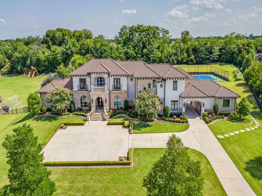 Major price improvement! Exquisite Entertainer's Estate on 2.1 Acre Tree Lined Lot. This estate is nestled on a tranquil cul-de-sac in a prestigious gated community offering privacy and serenity. Meticulously crafted with exceptional attention to detail, the home features extensive hardwood flooring with a stunning contemporary luxury design. Step into the grand foyer that leads to an elegant formal dining room, sweeping wrought iron staircase, and a cozy sitting area creating an inviting atmosphere. At the heart of the home lies a chef's dream kitchen-complete with quartz countertops, a Thermador refrigerator, Wolf appliances, two dishwashers, an entertainer's wet bar with a Sub-Zero, and large island with built-in table for casual dining. The kitchen flows seamlessly into the great room accented by wood beams, a striking floor-to-ceiling marble fireplace, and a wall of windows overlooking the backyard oasis. The private master suite is a true retreat with breathtaking pool views, private patio, dual vanities, a soaking tub, a walk-in double headed shower, updated flooring, and spacious closet with built-in safe room. Designed for entertaining this home also features a game room, an expansive wet bar and state-of-the-art media room. Continue upstairs to three bedrooms, three baths, loft and living area. Recent updates to multiple bathrooms and flooring. Step outside to your private resort-style back yard featuring an expansive pool with in-water table and bar stools, fire bowls, a water features and a spa. Entertain effortlessly in your outdoor living area with kitchen and fireplace. For the active lifestyle, enjoy an all-in-one lighted tennis, pickleball, and basketball court. Additional amenities include a 5 car garage with gated courtyard for added privacy and security. Ideally located minutes from premier shopping, dining and major highways. Zoned to LOVEJOY ISD. See Full List Of Updates In Transaction Desk.