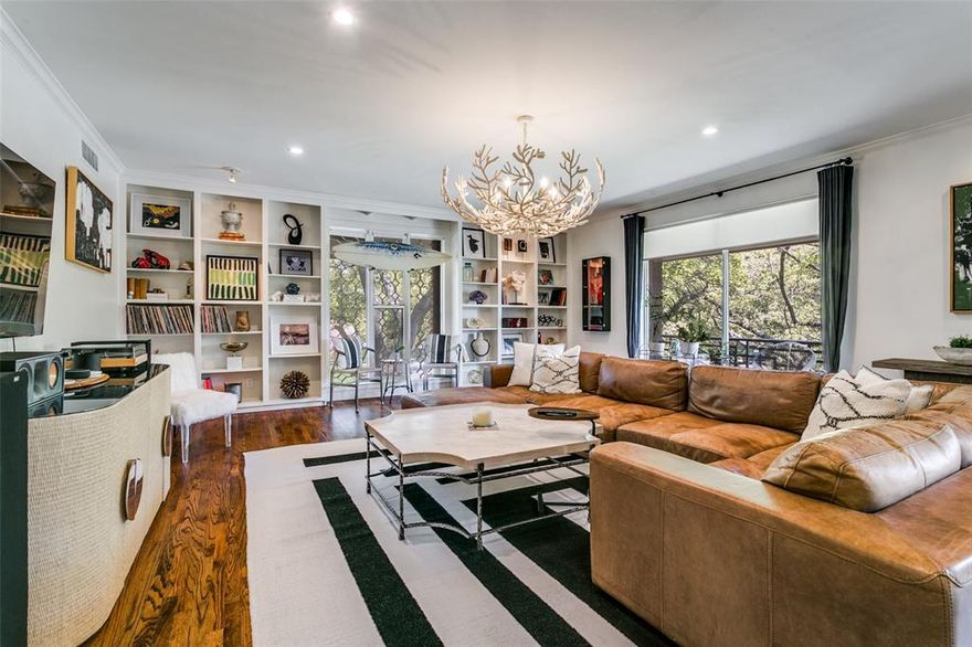 Tucked in the heart of Preston Hollow, 6332 Bandera APT D offers a rare blend of tranquility and convenience near Preston Center and the Park Cities. This fully remodeled, second-story residence lives like a private retreat, surrounded by mature oak trees and filled with natural light. A mudroom-style entry opens to a spacious living area with custom shelving, a powder bath, and serene tree views. Two expansive 40-foot balconies create a true indoor-outdoor feel. The kitchen and dining flow seamlessly with an oversized island, walk-in pantry, and ample storage.

The primary suite features peaceful tree views, dual vanities, a soaking tub, separate shower, and two walk-in closets. The secondary bedroom includes an en-suite bath and generous storage, ideal for guests or a home office.

Smart home features include security, thermostat control, and electric blinds. Washer, dryer, and refrigerator are included. The HOA covers all utilities except WiFi, along with exterior maintenance and a community pool. Two covered parking spaces included.