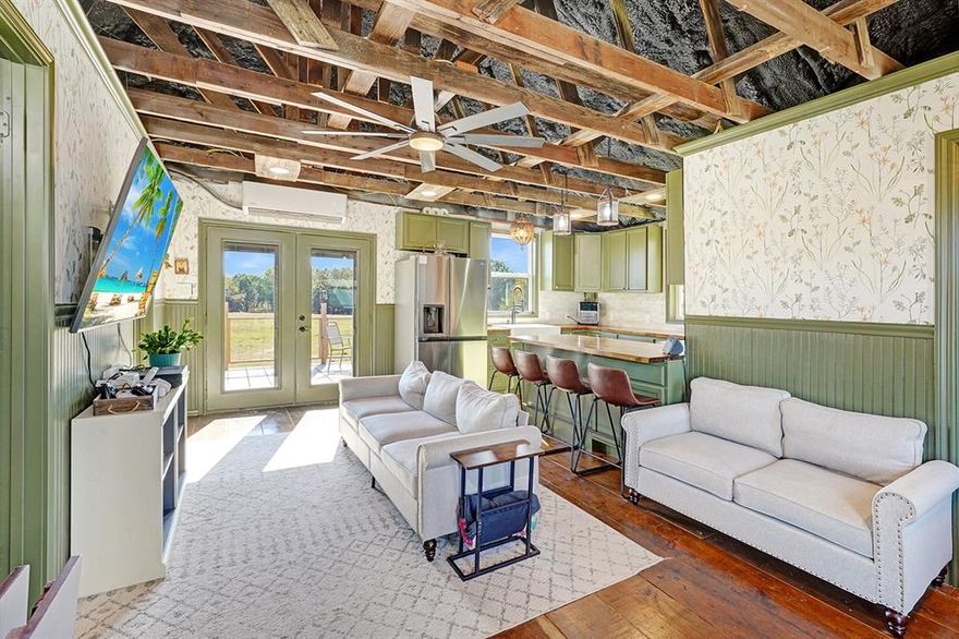 Use of Preferred  Lender will offer to pay .75 points of buyer’s closing costs. Call TODAY to see if you Qualify!
Unique Rustic Barndominium on Over 10 Acres! Discover the perfect blend of rustic charm and modern living in this stunning 2-bedroom, 1-bathroom situated on over 10 acres of breathtaking countryside. This property offers expansive views and ample space for relaxation, recreation, and work, making it a rare find. The spacious living areas feature exposed rafters that enhance the open feel, complemented by wide plank wood floors that add warmth and character. The gourmet kitchen boasts an open concept design that seamlessly flows into the living area, featuring butcher block countertops, a beautiful travertine backsplash, and a farmhouse sink with stunning views of the land. It comes equipped with stainless steel appliances and bar seating for casual dining. The master suite is thoughtfully located at the back of the home for added privacy and includes a private entrance into the rustic glam bathroom with double sinks on a repurposed dresser, elegant gold accent mirrors, and a tiled shower and tub area. The second bedroom is designed with a custom closet system, offering versatile storage options. Outdoor living is equally impressive with an expansive back deck, perfect for hosting gatherings or enjoying tranquil sunsets. Beneath the house, there’s an open stable area ideal for animals or extra storage. The property is fully fenced and cross-fenced, featuring an RV hookup complete with water, sewage, and electricity, along with a built patio for convenience. Additionally, a designated garden area includes a greenhouse and a fenced space ready for your gardening projects.Don’t miss this incredible opportunity to own a piece of paradise! Whether you’re looking for a serene retreat or an active lifestyle, this Barndominium has it all.