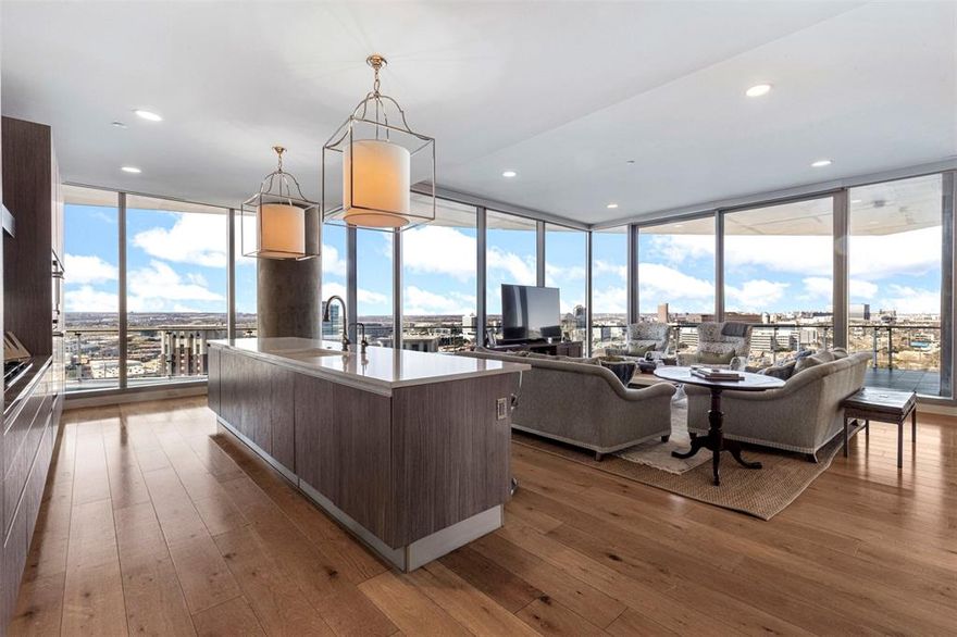 Experience modern sophistication in this exceptional residence located in the vibrant heart of the Harwood District in Uptown Dallas, masterfully designed by world-renowned French architect Jean-Michel Wilmotte. Ideally situated just minutes from the Park Cities, the American Airlines Center, and Love Field, the home is surrounded by the city’s finest dining, shopping, and nightlife.

This elegant three-bedroom, three-and-a-half-bath residence offers sweeping panoramic views of Dallas, showcased from two expansive private terraces—each appointed with a fireplace for year-round enjoyment.

Thoughtfully curated with elevated materials and designer finishes throughout, the home features marble and wood flooring, custom closets, and motorized shades for effortless living. The layout seamlessly blends form and function, offering a gracious living room, a gourmet chef’s kitchen, and a wet bar adjacent to the formal dining area—perfectly suited for both refined entertaining and everyday comfort.

Additional features include a walk-in pantry with refrigerated wine storage, two home offices and unparalleled views throughout the residence. The primary suite serves as a serene private retreat, complete with a spa-inspired bath and his and her walk in closets. Two guest bedrooms, each with en-suite baths, provide privacy and comfort for family and visitors alike. A rare benefit, the home comes with 2 two-car garages further enhancing the home’s exceptional offering.

Residents enjoy unmatched building amenities, including 24-hour valet and concierge services, car wash service, EV charging, and secure gated parking. Exclusive access is provided to a state-of-the-art spa, fitness center, yoga studio, two pools, wine cellar, social lounge, dog park, and direct access to the Katy Trail. Secure elevator access and a full-time professional staff complete this luxury living experience.