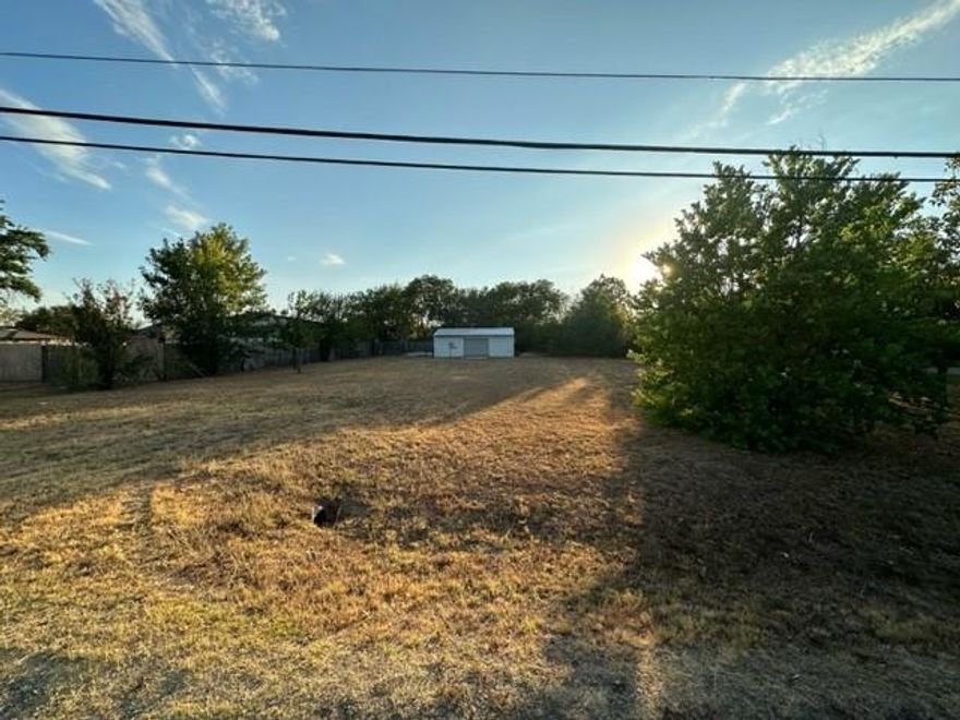 GREAT INVESTMENT OPPORTUNITY!!! Lot is 14,000 square feet. Single family or multi-family (verify with city). NO MOBILE HOMES. Beautiful corner lot with trees! Property includes large 28 x 20 metal building with electric on concrete slab. Near downtown Venus, Fielder Park, and schools.