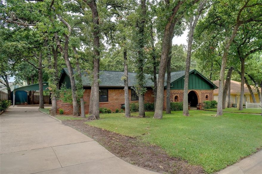 Pride of Ownership Shines in Every Detail!

Nestled on a beautiful wooded lot just minutes from DFW Airport, this exceptional home blends comfort, charm, and functionality. Thoughtfully designed and freshly updated with new carpet and interior paint, it feels clean, bright, and move-in ready.

Step inside to rich Acacia wood flooring and French doors leading to a versatile study or library with floor-to-ceiling shelving. The inviting family room features warm natural tones, a cozy wood-burning fireplace with custom cabinetry, and an open layout ideal for gatherings.

The gourmet kitchen offers granite countertops, custom cabinetry, under-cabinet lighting, stainless appliances, a premier water filtration system, smooth-top range, second oven, and a large breakfast bar. Enjoy meals by the bay window overlooking the screened-in patio, surrounded by additional built-ins.

A spacious pantry with freezer space adds great storage, and the flexible second living area offers endless possibilities. The owner’s retreat includes two walk-in closets and a luxurious ensuite bath.

Outside, enjoy a 2-vehicle carport, air-conditioned workshop, greenhouse, and three storage buildings—all with electricity. Major updates include a new roof (2021) and exterior paint (2022).

? A rare gem offering serenity, space, and fresh updates. Schedule your private showing today!