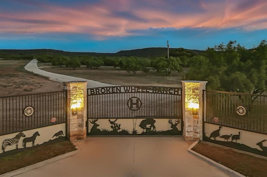 Just 30 Miles South of Abilene you will find an incredible turn-key ranch operation that blends unmatched recreation, income-producing opportunities, and BREATHTAKING VIEWS across 550 pristine acres. Whether you're dreaming of a working ranch, premier hunting retreat, event venue, or private family escape — this property is fully loaded. Every inch is thoughtfully developed, meticulously maintained, and positioned to generate income while offering unforgettable experiences. This high-fenced ranch is home to trophy game including red stag, zebra, axis, fallow deer, whitetail, mouflon, and more. Immaculately maintained roads and trails wind through beautiful oaks, mesquites, and open fields, providing access to seven tanks, five cultivated fields, and a stocked lake featuring bass, catfish, crappie, bluegill, and even koi. Near the water on a hill sits the showstopping saloon-style venue, built in 2021 and already proven for hosting iconic events—Kevin Fowler and The Bellamy Brothers have played here. This could make a one-of-a-kind wedding venue. It includes a bar, stage, branded tables and chairs, bathrooms, generous parking, and five RV hookups, creating a ready-to-go venue with unforgettable lake views. The beautifully designed horse barn includes living quarters, a large tack room, hay storage, fenced turnout, and a round pen. Enjoy morning coffee with a view of the cross on the hill or unwind by the firepit. It's perfect for recreational riding or future short-term rental potential. The hunting lodge features three bedrooms, two baths, and a cozy log cabin vibe. Nearby, a large shop offers a skinning room, walk-in cooler, additional lodge space with bunks for extra guests, a full kitchen, restroom, and an office with soaring ceilings and a second saloon-style finish to match. A shooting range, feeders and blinds throughout, two gated entrances, loafing sheds, equipment barns, additional shop space, and fenced cattle pasture make this a complete setup. COME SEE!