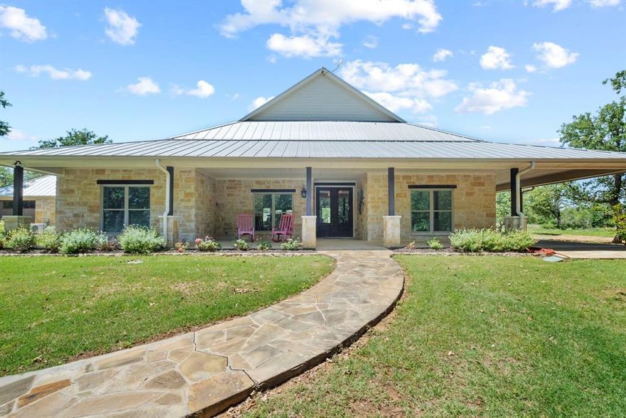 COUNTRY PARADISE! 379+ acres with a stunning 2800 sf spacious, open-concept home with 4 BR and 2.5 baths. One BR is converted to an office with a view! This home offers a blend of comfort and style with the kitchen being a haven in every sense of the word. 2-car garage section is temporarily a playroom-carpet and hvac,. There's a 2400 sf shop with 200 amp power - ample space for projects or storage. Revel in the beauty of the landscaping of post oaks, lush grazing pastures and a 12 ac reservoir with a depth of 25' when full. The perimeter fencing, along with crossed-fencing and cattle pens, ensures efficient management for livestock. For outdoor enthusiasts, there 4 hunting blinds, 5 feeders for memorable hunting experiences. Too much to list. Whether you're seeking a peaceful retreat, a working ranch or simply a place to reconnect with nature and fishing, this breathtaking land offers endless possibilities and a timeless beauty that will capture your heart from the moment you arrive.