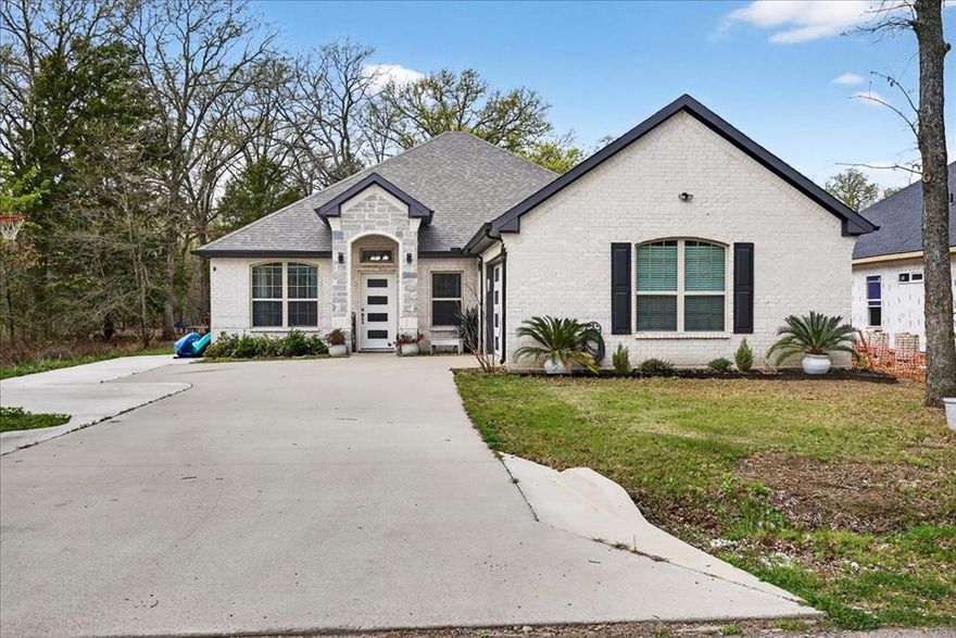 Beautiful Brick & Stone Home in Desirable Gated Community! This stunning 4-bedroom, 2.5-bath home offers comfort, style, and plenty of space for everyday living and entertaining. The home features a side-entry 2-car garage with durable epoxy floors and an oversized concrete driveway, providing ample parking for guests, boats, or additional vehicles. Step inside to an open-concept living, dining, and kitchen area designed for both functionality and gathering with family and friends. The large primary suite offers a relaxing retreat, complete with a spacious bathroom designed for comfort and convenience. Located in a highly desirable gated neighborhood, residents enjoy outstanding community amenities including a swimming pool, tennis courts, pickleball courts, private dock, boat launch, and community center—perfect for an active lake lifestyle.