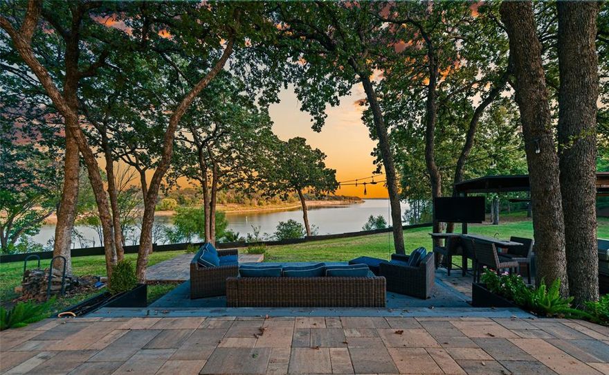COMPLETELY RENOVATED 2-ACRE  WATERFRONT ESTATE ON LAKE GRAPEVINE OFFERING COMPLETE SOLITUDE & PRIVACY! It is one of the few Lake Grapevine waterfront properties that have sold under $2M in the last couple of years. An extra bonus is the beautiful catch-and-release pond on the NW side.  Surround yourself in the luxury of this distinctive estate boasting a floor-to-ceiling fireplace, an open-concept floor plan, an updated guest bathroom, a temperature controlled wine grotto & soaring wood-beamed ceilings with skylights that flood the home with natural light. The chef in your family will love the beautifully remodeled kitchen showcasing custom cabinets, stainless steel appliances, a Bosch cooktop, under cabinet lighting & a large island with a breakfast bar. Pamper yourself in the lavish primary suite offering sliding glass doors leading to the deck & lake, a freestanding tub, walk-in shower, dual sink extended vanity, updated fixtures & a massive walk-in closet with washer & dryer connections. Entertain in the huge game room featuring a wet bar area with a mini fridge, or be productive in the home office with a built-in desk & cabinets. Wall-to-wall retractable pocket doors separate the primary suite, home office, and game room creating 3 individual destinations. The secondary downstairs bedroom is ideal for a mother-in-law suite. Paradise awaits you in this incredible backyard including a pool with a large patio area, an expansive wrap-around deck & patio with plenty of room for a fire pit, plus an outdoor kitchen with a kegerator & a bar area with a TV. This breathtaking lot offers tons of mature trees, lush landscaping & an abundance of wildlife. An electric gate leads to the attached 2 car garage with glass paneled garage doors & the detached 2 car garage with a workshop & storage area. Highly sought-after Flower Mound schools. Take a first-person look at this gorgeous home! Click the Virtual Tour link to see the 3D Tour!