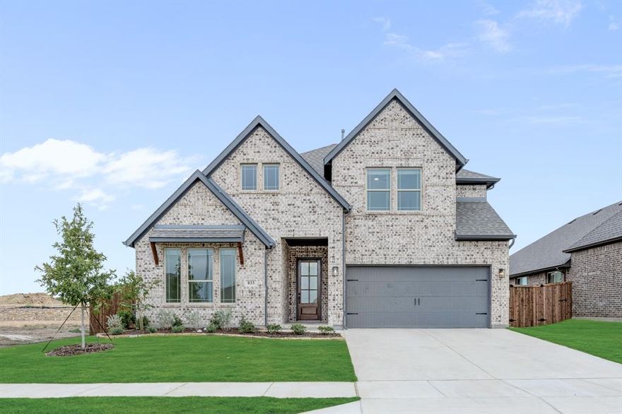 NEW & NEVER LIVED IN! The Violet II by Bloomfield Homes is a thoughtfully designed two-story home that blends open living spaces with private retreats, offering 5 bedrooms, 4 full baths, and a 2-car deep garage on an oversized interior lot with a striking brick elevation accented by herringbone details. Inside, the wide foyer and upgraded 8’ front door set an inviting tone, leading into an open Family Room with tall ceilings, abundant natural light, and a striking upgraded stair rail with rod iron accents that overlook from the Game Room above. The Deluxe Kitchen is the true heart of the home, featuring upgraded painted cabinets with a pull-out trash can, quartz countertops, a raised panel back at the island, an upgraded faucet, designer tile backsplash, a walk-in pantry, and built-in stainless steel appliances, including a gas cooktop and wood vent hood, all illuminated by 3 pendant lights over the island. The first floor also offers a Bedroom Suite at the front, a Study that has been converted to a 5th Bedroom with full bath, and a private Primary Suite tucked at the back of the home with dual vanities, separate tub and shower with upgraded tile surround, and a large walk-in closet. Upstairs is designed for entertaining with a spacious Game Room that connects to the Media Room through double doors, plus 2 additional bedrooms. Throughout the home you’ll find thoughtful upgrades including site-finished wood floors from the entry to the Family Room, upgraded tile flooring in utility and baths, semi-frameless shower glass at the powder bath, and 2-inch faux blinds. Outdoor living is just as inviting with a covered porch, covered patio featuring a gas drop for your grill, full gutters, and professional landscaping. Located in the Wildflower Ranch community, residents enjoy resort-style amenities including a lazy river, playground, and trails,. Call or visit Bloomfield at Wildflower Ranch in Justin area to learn more today!