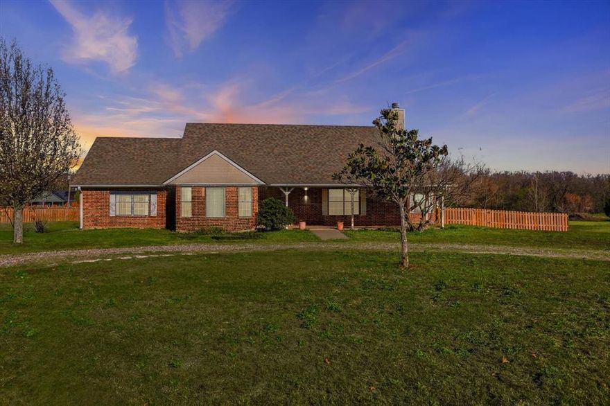Beautifully maintained home on a 1.5 acre lot offering space and comfort inside and out. The kitchen features custom cabinets, a center island, built in microwave, a solid surface countertops and opens to a large breakfast area with a patio door leading to a spacious concrete patio, perfect for enjoying the peaceful acreage views. A formal dining room is located just off the kitchen, providing additional space for entertaining. The spacious living room includes a wood-burning fireplace and plenty of natural light. The home offers large bedrooms, large walk-in closets, including a primary suite with a generous bath featuring double sinks with a makeup area, a jetted tub, and a separate shower. The large utility room provides abundant storage with custom cabinets, folding space, hanging rack and room for a freezer. Additional features include an attached covered breezeway carport leading to a two-car garage. Conveniently located near Trenton High School and offering the feel of country living while still being centrally located, with approximately a 20-minute drive to nearby cities such as McKinney, Sherman, Bonham, and Greenville.