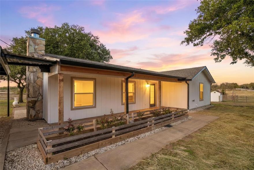 This 2001-built single story home was completely transformed in 2025 to feel brand-new, with all-new siding, trim, windows, all interior and exterior doors, LVP flooring, paint, lighting, and fans. Thoughtful updates include attic insulation, roof ventilation, and new outdoor 2.5 ton 14 seer Trane heat pump and new HVAC ducting for comfort and efficiency. Set on nearly 2.5 acres, the property is fully fenced, including divided pastures, and features a pre-fenced vegetable garden, fruit and Texas lilac trees, rose garden, and multiple outdoor living spaces. Enjoy a covered front porch, a back patio with a fire pit and gazebo, and a retreat-style backyard with solar lighting—perfect for entertaining, relaxing, or watching children and pets play. The barn has been updated for hobby farming or livestock, with cemented garage space, additional stalls, a chicken coop with solar door, goat pen, and plenty of storage. Extra sheds, a horse trailer, round pen, and select barn equipment convey. Pasture supports horses and goats with new fencing and easy-access gates. Located just 1 mile from Chisholm Trail Parkway, this property combines quiet country living with convenient 30 minute access to the museums, theatres and Stock Yard areas in Fort Worth, and only 50 minutes to Dallas.  Public water, private septic, and rural trash service provide modern conveniences. With extensive upgrades, charming landscaping, and versatile outdoor spaces, this home is ready for the next owner to enjoy the perfect blend of comfort, lifestyle, and country living.
