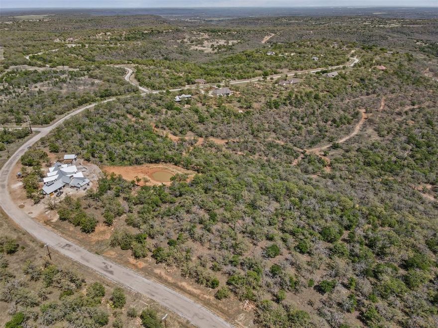 Discover the perfect place to build your dream home on this 1.058 acres wooded lot nestled in the scenic 7-R Ranch community in Gordon, Tx. With breathtaking views of Clayton Mountain and mature trees providing natural beauty and privacy, this property offers an ideal blend of peace and recreation. Located in a gated community rich with amenities, residents enjoy access to 3 swimming pools, a wildlife preserve, clubhouse, fishing lake with pier and boat dock, a horse facility, and even a CareFlight helipad for added peace of mind. The nearby Sundance Club adds even more luxury with a grill, bar, spa and other upscale offerings. Situated just 30 minutes west of Weatherford and only an hour to downtown Fort Worth, this property is perfectly positioned for both seclusion and convenience! Reach out to learn more about building options, deed restrictions and to start your journey toward owning a piece of paradise in 7-R Ranch!