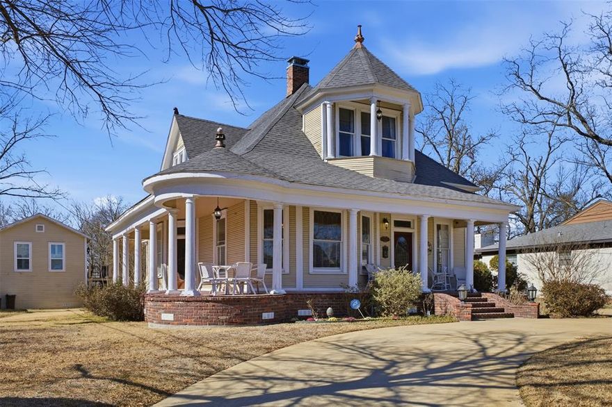 Historic Queen Anne Victorian Near Downtown Sulphur Springs Plaza

A rare opportunity to own a beautifully preserved Queen Anne–style Victorian just one block from the iconic Downtown Sulphur Springs Plaza. This exceptional historic home blends timeless architectural character with thoughtful modern updates and offers flexibility as a primary residence, second home, or income-producing short-term rental thanks to its unbeatable downtown location.

Originally designed with classic Victorian proportions, the home features a two-story design with three spacious bedrooms, each with its own ensuite bathroom providing comfort and privacy for owners and guest alike. Inside is a gorgeous formal entry with grand staircase, plus a secondary family staircase, three living areas, a formal dining room, all bathed in abundant natural light courtesy of the traditional cord-and-weight sash windows, and beautifully preserved period trim and moldings, all paired with a wonderfully updated interior.

Outdoor living is just as impressive with a wrap-around front porch and a fabulous brick courtyard that creates a private picturesque setting ideal for entertaining and large gatherings, complete with an accessible restroom from the patio area that adds a thoughtful and practical touch for hosting. Adding even more value is a bonus carriage house studio apartment, perfect for guest accommodations, short-term rental income, or a private home office, studio or workshop.
Located steps from the heart of Sulphur Springs, the Downtown Plaza is known for its vibrant atmosphere, restaurants, boutiques, festivals, live music, the famous glass-panel restrooms and water feature, making this location one of the most sought-after in the city.
Furnishings are included at the listed price, allowing for a seamless move-in or turnkey rental opportunity.
Limited showing times available. Schedule your private appointment today to experience this historic property.