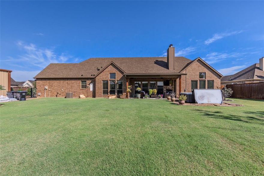 Welcome to this beautiful custom home by S. Clements in the desirable Mills of Caddo Mills community. Perfectly placed on a spacious half-acre lot, this well-designed home blends style, comfort, and everyday functionality—ideal for modern living. Inside, an open-concept layout is filled with natural light. With 4 bedrooms and 3.5 baths, this home offers generous space and elegant designer touches throughout. From the moment you enter, the quality craftsmanship stands out. The gourmet kitchen features custom cabinetry, granite countertops, gas cooktop, double ovens, walk-in pantry, and a large breakfast bar. A pocket office is located just off the kitchen, perfect for remote work or daily tasks. The living and dining areas flow seamlessly, offering an ideal layout for hosting gatherings. The private primary suite is a peaceful retreat with an en-suite bath that includes dual vanities, soaking tub, walk-in shower, and large closets. Three additional bedrooms are spacious and well-appointed for guests or family. Enjoy outdoor living on the covered patio with a cozy fireplace and gas starter—great for relaxing evenings or entertaining year-round. Built with quality in mind, the home includes energy-efficient cellulose insulation, radiant barrier, and a post-tension foundation for strength and long-term savings. There is a 24x44 workshop fully insulated with air conditioning for working on projects and storage.  The Mills offers a quiet, upscale setting close to schools and minutes from I-30. Whether commuting or enjoying small-town charm, this location offers the best of both worlds. Don’t miss the chance to own this stunning, well-built home in a community known for quality, comfort, and convenience.