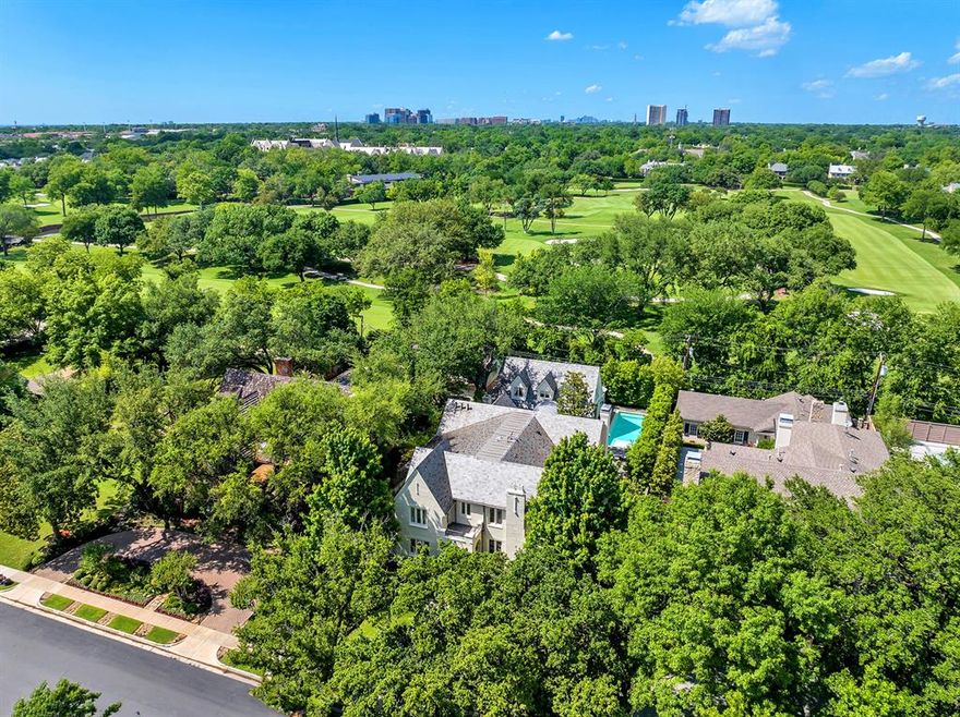This stunning Highland Park circa 1926 home was impeccably remodeled behind walls and expanded circa 2013-2014 and is now vacant (freshly staged) and available for immediate possession. 180-ft deep lot backs to the Dallas Country Club offering privacy and views from the 640 sqft remodeled full quarters over 3-car garage. Mahogany doors with linenfold detail open to a light-filled entry with a custom brass and steel stairwell. Handsome wainscoting adorns the entry, formal living room and dining room with Morning Glory crown molding and original stained glass windows. Three spacious living areas are on the first level, including a study with sitting area overlooking a private courtyard with an antique fountain. A vaulted family room opens to a conservatory with arched custom bronze steel doors leading to a Pennsylvania Bluestone terrace and pool with separate kitchen and bath. Gourmet kitchen with a custom Egg & Dart cabinetry, Ann Sachs tile, and SubZero-Wolf appliances opens to a breakfast room. One bedroom is downstairs and four en suite bedrooms upstairs, accessible by elevator. All bedrooms feature quartersawn hardwoods and Mahogany pocket doors.  Spa-like primary suite is adorned in Thassos and Statuary marble floors and baseboards, Statuary marble vanities and tub surround, and Waterworks fixtures.  Other amenities include slate roof, leaded coated copper gutters, outdoor fireplace and Pennsylvania Bluestone sitting area, a 64 kilowatt generator, and spacious alley with an oversized 3-car garage with additional parking pad. One could inexpensively replace some of hardscape in back yard with turf for a sizeable grassy play area. This is a rare opportunity that merges an exceptionally renovated historical home with a platinum Highland Park location that is a short walk to Highland Park High School, Highland Park Village and Dallas Country Club's clubhouse.
