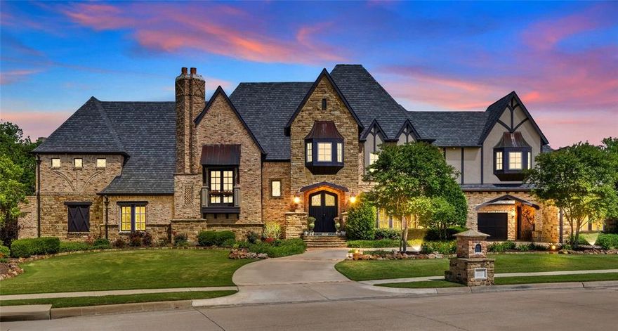 Nestled in one of the Dallas–Fort Worth area’s most exclusive gated communities, this stunning and authentic English Tudor estate is a rare find. Formerly a *Parade of Homes* showcase, this residence offers over 6,600 square feet of timeless elegance and luxury. From the moment you arrive, the home’s distinctive exterior makes a lasting impression. Clad in antique brick repurposed from a historic Southern Methodist University building in Dallas, it exudes rich heritage and architectural character. Step through the grand entrance into a world of thoughtful craftsmanship, where vaulted ceilings with exposed wood beams, Juliet balconies, and hand-distressed hardwood floors create an atmosphere of classic charm and sophistication. At the heart of the home lies a true chef’s kitchen, featuring a large eat-in island, custom knotty alder cabinetry, and exquisite Taj Mahal quartzite countertops. Entertain in style with a recessed wine grotto, or unwind in the underground home theater for a private cinematic experience. The luxurious main-floor primary suite is a peaceful retreat, complete with a cozy sitting area, a spa-inspired ensuite bath, and a dramatic two-story, boutique-style closet. A private guest suite with its own full bath, a designer powder room, and a two-story executive study complete the first floor. Upstairs, you’ll find three spacious bedrooms, three full bathrooms, a game room with a wet bar, a covered balcony, and a secondary laundry room for added convenience. Step outside into your own private resort, where a heated pool and spa with tranquil stone water features create a serene escape. The fully equipped outdoor kitchen and open-air living area—complete with a cozy fireplace—are perfect for year-round entertaining. A stately four-car garage, accessed through a gated porte-cochere, combines everyday convenience with architectural distinction. Search this home’s address on social media to see the video and 3D tour.