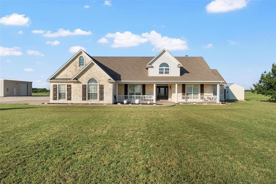 There’s nothing quite like the quiet of country evenings, where the only decision you’ll make at sunset is whether to sit on the porch swing a little longer or take one more stroll across the land. On just over 10.5 acres that produce hay, this property offers the kind of space and serenity most people only dream about. This home has been lovingly maintained and feels instantly welcoming. The open layout makes gathering easy, with a stone fireplace at the heart of the living room and a gourmet kitchen with granite counters, a gas cooktop, and an island ready for family meals and entertaining friends. The primary suite offers a whirlpool tub, separate shower, and dual sinks. Beyond the home, the huge workshop with a second story and plumbing for a full bath invites you to create, work, or play as you please. This is more than a house, it’s a chance to live the life you’ve been waiting for!