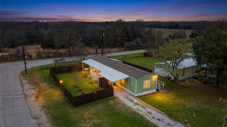 Lake Living at an Affordable Price.   This MOVE-IN ready 3-bedroom, 2-bath home sits on a large corner lot in the Lake Community of Pelican Bay.  Inside you'll find a bright open floorplan with stylish wood-look flooring, a spacious kitchen with custom painted cabinets, center island, breakfast bar, and plenty of room to gather.  Generous bedrooms and a full utility room with washer & dryer hookups add everyday convenience.  Privacy fence added, large covered carport and a matching shed for storage complete this Gem.  Just minutes away enjoy FREE community amenities including a boat launch, fishing pier, park, swimming area and a playground-perfect for soaking up the laid-back lake lifestyle.