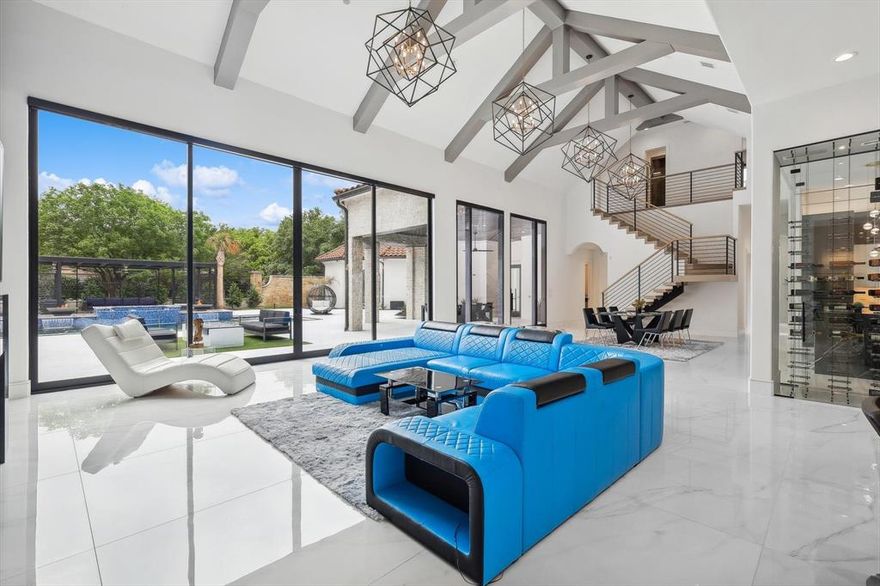 Modern mansion estate in West Frisco! Nestled within the esteemed Reserve at Starwood gated community, this estate offers unmatched convenience, just mins away from the Dallas Tollway, The Star, Legacy West, & PGA HQs. This Fully renovated modern masterpiece boasts 5-7-4+ formals, study, game room, media room, & a lavish pool. Positioned on a sprawling half-acre corner lot, the home boasts a redesigned backyard paradise.
Inside, sophistication reigns supreme with an incredibly open layout, soaring cathedral ceilings, and vast floor-to-ceiling windows that flood the interior with natural light, seamlessly blending indoor and outdoor living spaces. The expansive family room showcases a custom fireplace, while the chef's kitchen is a culinary haven with custom cabinetry, quartzite countertops, black-stainless appliances, walk-in pantry & dry bar. The secluded master bedroom retreat features FP with a wall of windows. This modern mansion blends modern luxury with an unbeatable location.