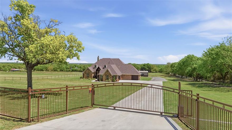 Welcome to a private estate where expansive Texas skies meet elevated country living. This custom-built residence showcases exceptional craftsmanship, upscale finishes, and a light-filled, open-concept design tailored for both everyday comfort and refined entertaining.
The gourmet kitchen is thoughtfully appointed with a propane cooktop, pot filler, wine refrigerator, beverage center, and generous counter space and storage—ideal for hosting gatherings of any size. The owner’s suite offers a peaceful retreat, featuring a spacious walk-in closet and a spa-inspired bath complete with a personal sauna and plumbing in place for a future soaking tub.
Outdoors, the resort-style pool creates a true centerpiece, featuring a tanning ledge, waterfall, and bar-top seating, all complemented by a fully equipped outdoor kitchen designed for effortless entertaining.
Set on approximately 10.25 acres of level, highly usable land with premium sandy loam soil, the property is fully fenced and cross-fenced, offering mature trees, open pasture, and well-designed turnouts suitable for horses and cattle. Equestrian and utility improvements include a 30x50 split shop with four stalls and a tack room, covered trailer parking, and a dedicated man cave with bath, providing both function and flexibility.
Ideally located in a peaceful setting just minutes from town, this exceptional property offers a rare combination of privacy, practicality, and modern luxury—capturing the very best of refined rural living.