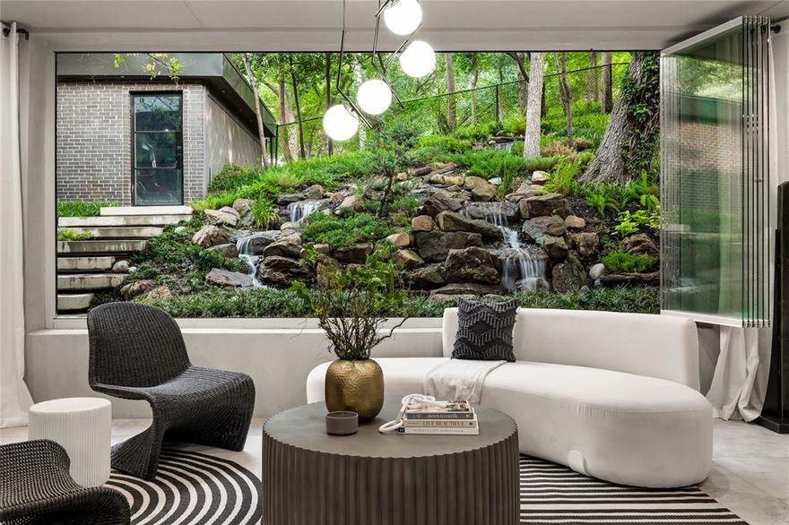 Architectural masterpiece in what feels like a secluded, forested setting located in highly desired area of Bluffview in the heart of Dallas. Tucked beneath a lush canopy of mature trees in one of Dallas’ most coveted neighborhoods, this reimagined modern estate is a masterclass in architectural serenity, design precision, and luxurious indoor-outdoor living. One of the most breathtaking and one-of-a-kind features of this home is the multi-tiered, stone-lined waterfall that cascades down over 100ft of moving waterfalls and streams. Designed to echo a natural mountain spring, this custom water feature is more than ornamental, it's a tranquil centerpiece visible from nearly every angle of the main living spaces. The gourmet kitchen is a chef’s dream with top-tier appliances, striking black and brass finishes, and built in fridge. Head upstairs to the primary bedroom suite with vaulted wood ceilings and an ensuite bathroom to die for. Enjoy the sculptural soaking tub, steam shower with rainfall shower head, dual vanities, a custom walk in closet with a large island and extensive storage. This one of a kind 5 bedroom 4 and half bath home is perfect those who want to escape the Dallas rush but still remain in the heart of Dallas.