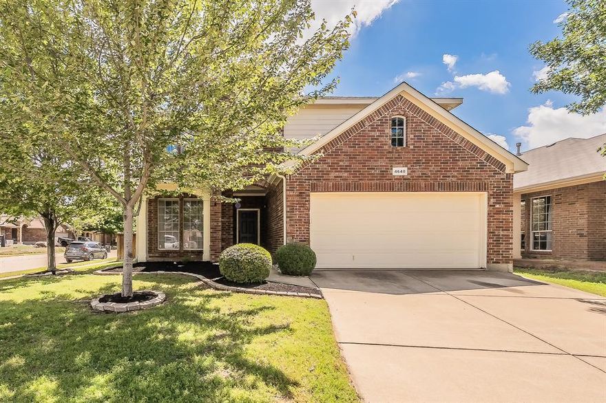 Beautiful two-story home - The open-concept main living area is ideal for everyday living and entertaining. The inviting living room features a decorative gas fireplace with stone surround and wood mantel. The kitchen offers white cabinetry, a glass tile backsplash, 5-burner gas cooktop, large walk-in pantry, and an eat-in space overlooking the backyard. A private first-floor office with closet provides flexibility for working from home or can serve as a guest room. A convenient half bath completes the downstairs. Upstairs, all bedrooms are located together along with a large game room featuring a storage closet, projector, and screen—perfect for movie nights, gaming, or a play space. The spacious primary suite includes a sitting area and a well-appointed bath with garden tub, separate shower, and a good-sized walk-in closet. Situated on a desirable corner lot, the home offers a larger backyard with room to play or entertain under the covered patio. HOA amenities include a community pool, playground, walking trails, and private ponds. Conveniently located in north Fort Worth near shopping, dining, and the Alliance corridor.