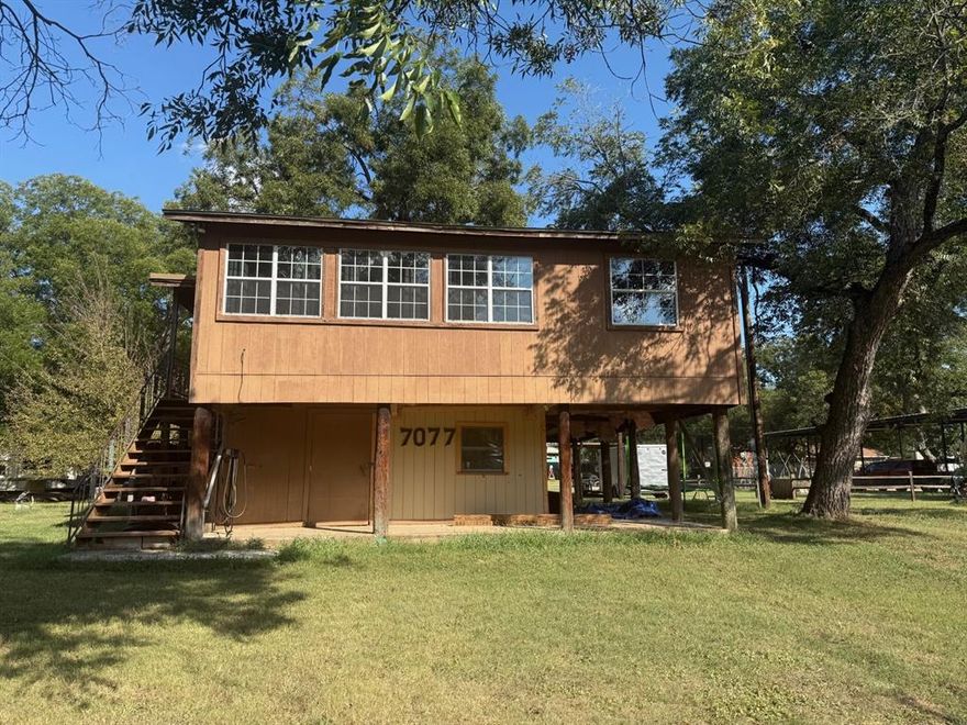 Get out to the countryside and enjoy the Brazos River!  Fun for your family outings Kayaking and utilizing the boat ramp to launch your jet skis or boat!  Plenty of River to spend the day out in enjoying the fresh air and do a little fishing and relaxing on the water tubing with family!  This property is so close to navigate to and from river by using the community boat ramp!  Enjoy this property for a second vacation home or use for your year-round residence.  This property is a 2 bedroom and 1 bath but holds opportunity, to build an additional room if needed.  First floor will need some construction completion of a laundry room and storage of walls and ceiling surface.  The community does offer a clubhouse and golf course.  Come see this property for all of your ideas of how you can make it your own!
