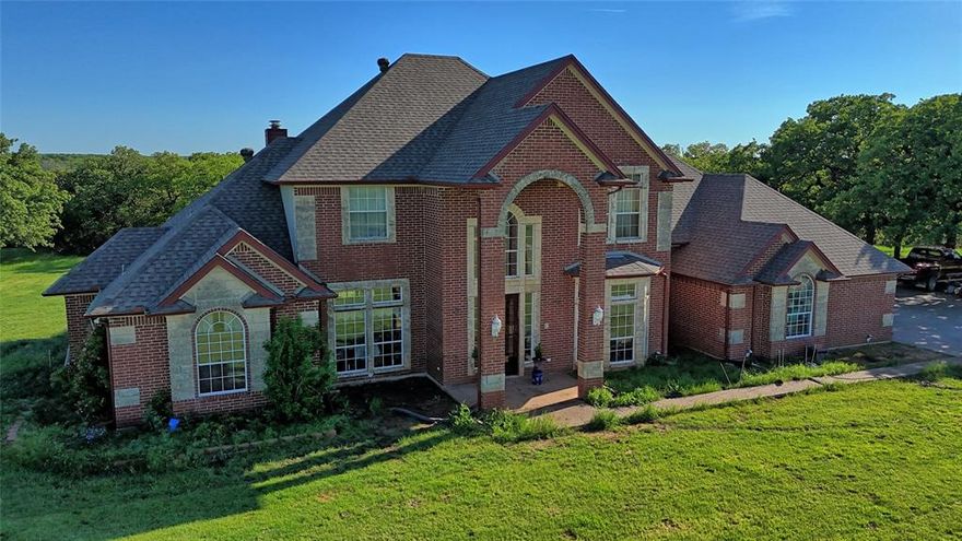Tucked away on 20 beautiful acres, this two-story brick home blends rustic charm with plenty of room to roam. With 3 bedrooms, 2.5 baths, two cozy living areas, and two dining spaces, there’s no shortage of space to spread out and stay awhile. The massive kitchen is a dream—complete with built-ins, a large island, and plenty of room for gathering. A warm fireplace anchors the main living room, while an upstairs balcony offers sweeping views of the countryside—perfect for morning coffee or sunset watching. Need a place to work? The home office has you covered. Outside, a large barn is ready for horses, storage, or your next big project. Whether you're dreaming of wide-open spaces or a place to hang your hat and call home, this one’s got the heart and the land to match.