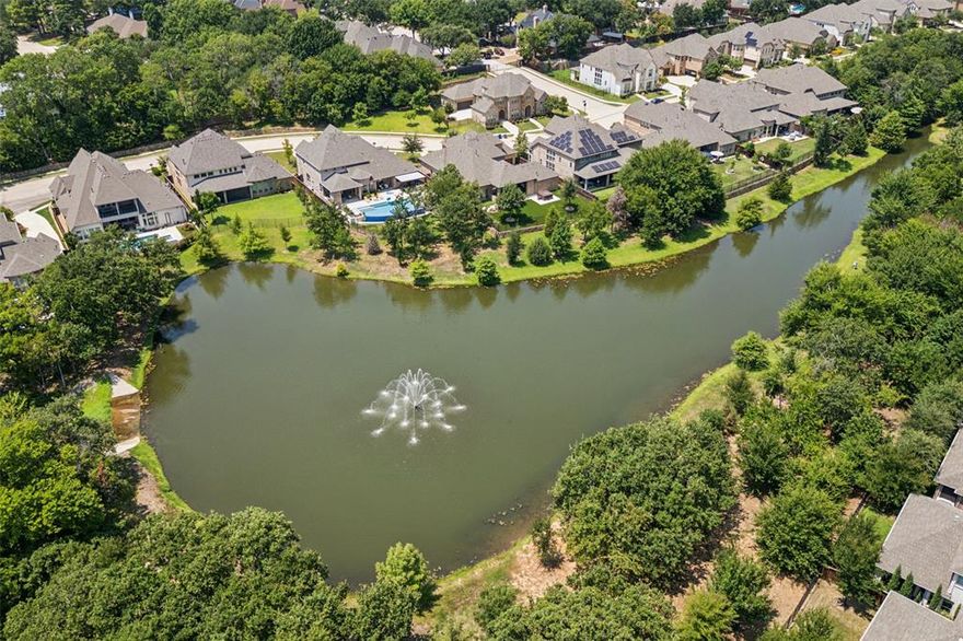 Introducing a stunning 4-bedroom, 6-bathroom lake front property in the highly desirable gated community of Creekside at Colleyville! This luxurious residence exudes elegance and sophistication, featuring a peaceful backyard with views of a serene lake and an enchanting illuminated fountain. Entertain throughout the year in the magnificent backyard, which includes a summer kitchen with a gas grill, an outdoor living space with a fireplace, turf with year-round beauty, and a heated pool and spa. The kitchen boasts top-of-the-line Wolf and Sub Zero appliances. The open layout on the main floor seamlessly connects the kitchen, living room, and dining area, creating an ideal space for effortless entertaining. The home also includes a private home office, a versatile game room, and a home theater room. Additionally, the property benefits from an HOA that takes care of all front yard maintenance. This, combined with the backyard turf, allows for a maintenance-free, relaxing lifestyle!
