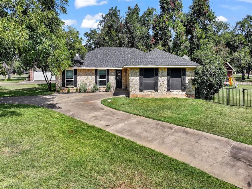 Welcome to 6103 Prospect Hill Drive, a beautifully maintained corner-lot home tucked inside the sought-after Pecan Plantation community. This amenity-rich, gated and guarded neighborhood truly has it all—multiple pools, parks, a marina, tennis, restaurants, golf courses, and so much more. Conveniently located near the back gate and club, this home offers both privacy and easy access to everything the community has to offer.

Step inside and you’ll immediately notice the abundance of natural light that fills the home, highlighting the open and inviting layout. The spacious living room features soaring ceilings and a stunning stone wood-burning fireplace that creates a cozy yet impressive focal point. Just off the living area, you’ll find a wet bar that makes entertaining family and friends effortless.

The home offers three generously sized bedrooms and three full bathrooms, providing plenty of space for everyone. There’s also a versatile bonus room that can easily serve as a home office, workout room, playroom, or hobby space. Every detail has been thoughtfully designed to balance comfort and functionality.

Outside, the fenced yard is perfect for pets or play, and the extended concrete patio (added in 2024) provides a wonderful spot for outdoor gatherings or quiet evenings under the stars. A huge circular driveway not only adds to the curb appeal but also makes parking and hosting guests simple and convenient.

This property has been beautifully updated with all the big-ticket items already taken care of: new roof (2024), new HVAC (2024), farmhouse sink (2025), remodeled primary bathtub (2024), new floors (2023), and new windows in the living areas and secondary bedrooms (2024). These thoughtful upgrades mean peace of mind for years to come.

If you’ve been dreaming of a move-in ready home where modern updates meet small-town charm and resort-style living, this one checks all the boxes. 6103 Prospect Hill Drive is more than a house—it’s a lifestyle.