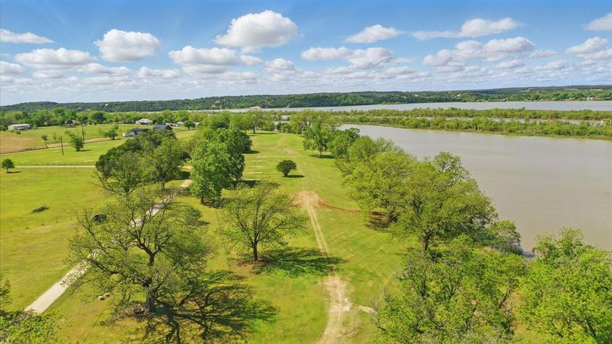 Located just north of the charming and historic town of Granbury, Texas, this extraordinary 53.739-acre property offers the perfect blend of natural beauty and recreational opportunities. With over 1,665 feet of pristine Brazos River frontage, this unique parcel features stunning views, abundant wildlife, and a variety of amenities for outdoor enthusiasts and investors alike. Whether you're seeking a private retreat, a place to build your dream home, or an investment opportunity, this riverfront property offers it all. With an abundance of wildlife, the property is perfect for hunting, fishing, or simply enjoying the natural splendor. Don’t miss the chance to own a piece of Texas paradise! Riverfront Access: Enjoy expansive river frontage with direct access to the Brazos River. A private boat ramp allows for easy launches, perfect for fishing, boating, or simply soaking in the serene waters.Spacious Workshops & Storage: A 12x20 boat shop and a large 40x60 workshop provide ample space for storage, projects, and equipment.RV & Recreational Sites: With 32 RV spots, this property has potential for RV park development or simply for accommodating guests and family on their visits.ature & Views: Towering live oak trees provide shade and natural beauty throughout the property, enhancing the serene atmosphere. Several elevated spots offer incredible views of the river and surrounding landscape.Water Wells: Two water wells are on the property, with one producing 40 GPM to ensure a reliable water supply for all your needs. Minerals do not convey.