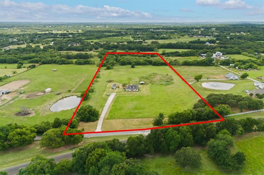 $10,000 CLOSING COST ASSISTANCE!
A rare opportunity to own 14 acres with a home in this area under $1M—perfect for those dreaming of space, privacy, or a future family compound. Located outside city limits yet within Mansfield ISD, this property offers the freedom and flexibility buyers are searching for.
The home sits thoughtfully within the front 4 acres, allowing the remaining acreage to be used however you envision—additional homes, a workshop, livestock, recreation, or long-term investment. The land is mostly flat with endless potential.

Inside, enjoy an open-concept layout connecting the living, dining, and kitchen areas, complete with two separate sitting spaces in the living room. The home features wood-look ceramic tile throughout the main living areas, granite countertops in the kitchen and baths, and fresh interior paint. Carpet is limited to the primary bedroom and 4th bonus room.
The primary suite includes an adjoining flex room—ideal for a 4th bedroom, home office, nursery, or craft room, offering flexibility for changing needs.
A NEW ROOF will be installed prior to closing for added peace of mind.
An added bonus: 13 acres are Ag Exempt for hay, creating an excellent opportunity for income production—either by selling hay or leasing the land.
Whether you’re looking to build a multi-generational family compound, create income-producing land, or simply enjoy wide-open space with NO CITY Restrictions, this property delivers rare versatility and long-term value.
**Tiny House will be removed!**