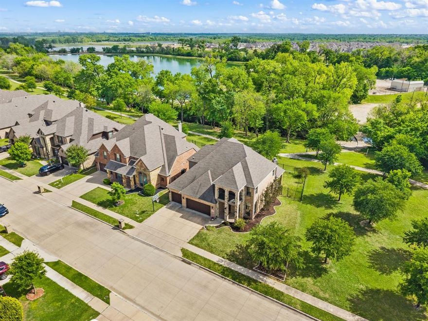 Nestled in the desirable Lakes of River Trails East, this beautiful home offers serene water views and is surrounded by mature trees and lush green space. An inviting entry opens to the spacious living and dining areas, where large windows frame picturesque views of the natural surroundings. The living room features a stunning stone fireplace, creating a warm and welcoming focal point. The private primary suite is complete with a spacious en-suite bathroom and a generous walk-in closet. Upstairs, you’ll find three additional bedrooms and an expansive Gameroom or media room. Enjoy outdoor living on the covered balcony upstairs overlooking the peaceful setting. Additional highlights include a walk-out attic with decking for exceptional storage space. Ideally located in HEB ISD and offering convenient access to Downtown Fort Worth, the Mid-Cities, and DFW International Airport.