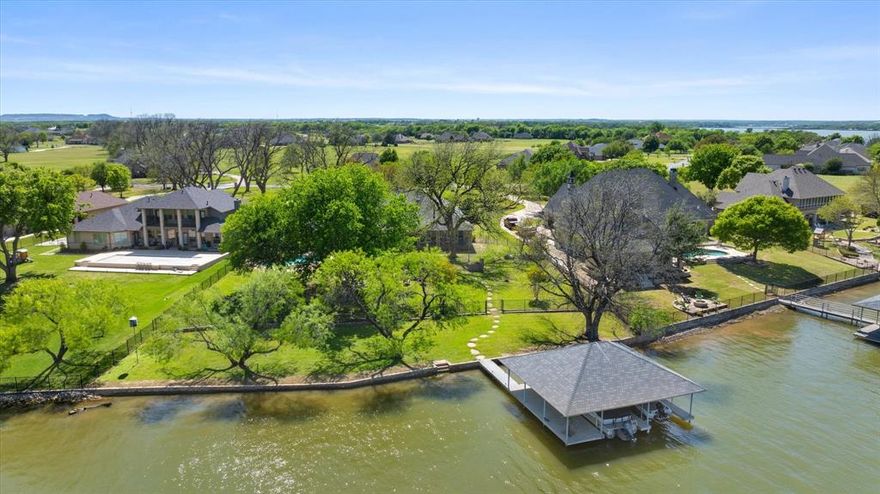 Stunning Total Renovation on the Main Body of Lake Granbury
Experience unparalleled luxury in this masterfully reimagined estate, situated on 1.47 private acres within the exclusive gated community of The Peninsula. No expense was spared in this complete, top-to-bottom renovation, where every inch of the 3,523 sq. ft. floor plan has been touched. From the newer roof to the exquisite new wood flooring and designer LED lighting throughout, this home offers the feel of new construction with the established charm of lakefront living.
The heart of the home is a chef’s dream featuring new premium countertops, a massive island, and high-end built-in appliances. Each of the three spacious bedrooms serves as a private retreat with fully updated ensuite baths, including all-new custom showers, tubs, and fixtures. The primary suite remains the crown jewel, offering a private fireplace and a spa-like bath experience.
The outdoor oasis is designed for ultimate relaxation and entertainment. The heated gunite pool was fully redone recently and features elegant water features and a cooling misting system. For the boating enthusiast, the private dock on the main body of the lake is equipped with double boat lifts and a pest-control misting system for bug-free evenings on the water.
Buyer to verify accuracy of all information including room & lot sizes, schools, taxes, amenities, etc. Neither Seller nor Listing Agent make any warranties or representation as to accuracy.