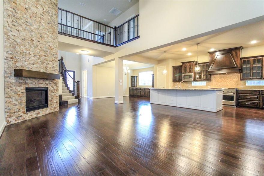 Discover this beautifully designed 5-bedroom, 4.5-bath home, ideally located near I-35 and the President George Bush Turnpike. With premier shopping, dining, and entertainment just minutes away, convenience meets comfort in one of the area’s most sought-after communities.

Step inside to soaring ceilings, sun-filled spaces, and an open floor plan designed for modern living. The chef’s kitchen boasts commercial-grade appliances, a large granite island, and endless counter space—ideal for everyday meals and effortless entertaining.

The main-level primary suite offers a serene retreat with a spa-inspired bath, while a private guest suite ensures comfort for visitors. Upstairs, enjoy a versatile game room, media room, and additional bedrooms that offer space for everyone.

Relax outdoors on the expansive covered front porch overlooking the greenbelt, or take advantage of nearby walking and biking trails. A 3-car garage completes the package with plenty of storage. Move-in ready and thoughtfully appointed, this home is the perfect blend of luxury and practicality.