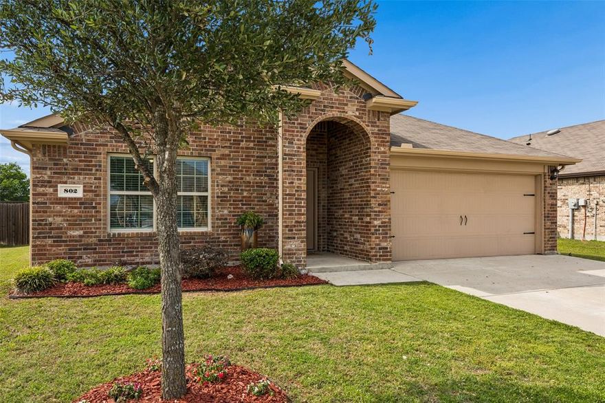 Magnificent in Magnolia, 802 Rustic Way offers the kind of space, flexibility, and everyday ease that makes life feel lighter. With 4 generously sized bedrooms, 2 full baths, and a layout that balances open gathering spaces with privacy where you want it, this home lives larger than its 1,577 square feet suggest.Arched details welcome you in, while high ceilings and a spacious open-concept living, dining, and kitchen area create the true heart of the home. The kitchen is both stylish and practical with designer navy blue cabinetry, thick granite countertops in timeless black and white, electric cooktop and oven, refrigerator that conveys, designer hardware, and a motion-sensing pantry light that makes daily life just a little easier. Lutron dimmer switches and LED lighting throughout the home add both efficiency and ambiance.Two secondary bedrooms share a full bath at the front of the home, while a third bedroom is ready to flex as a guest room, office, or workout space. Privately set at the back of the home, the primary suite enjoys peaceful views of the backyard and offers abundant natural light, an oversized shower, double sinks, generous linen storage, and a large walk-in closet.Out back, the oversized fenced yard is a standout feature with room to relax, play, garden, or dream bigger. Rustic backs to municipal property, creating a beautiful tree-lined backdrop in place of rear neighbors. Out front enjoy easy access to the Magnolia neighborhood trail leading to the elementary school, parks, playgrounds, and nearby sports practice fields.Even the garage has been elevated with an epoxy floor finish, adding a polished, easy-care touch to this already thoughtfully upgraded home. Magnolia is known for its resort-style community pool, neighborhood events, food truck rallies, monthly market, and strong sense of connection. Beautiful Rustic is only for the discerning buyer looking to have it all And leave money in the bank when you are lucky enough to snag the keys.