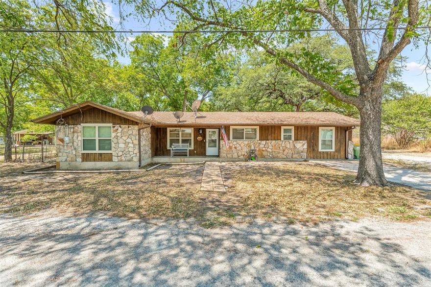 Welcome to this charming 1502 square foot home nestled deep in the heart of Hico, TX. This delightful 3 bedroom, 2 bathroom house boasts a rustic aesthetic with its rock and wood construction. The third bedroom offers incredible versatility, serving as either a comfortable bedroom or a spacious game or media room. The well-appointed and roomy kitchen provides ample space for culinary endeavors and entertaining guests. Situated on nearly half an acre, this property offers a generous backyard, partially fenced for added privacy. The back area offers flexibility, providing room for storing extra vehicles or trailers, as well as the potential for creating inviting outdoor grilling or sitting areas. Located in close proximity to an array of delightful restaurants and retail stores, including Green Canoe Outfitters, Blue Star Trading Company, and Wiseman House Chocolates, this property immerses you in the vibrant heart of Hico's cultural and culinary scene.