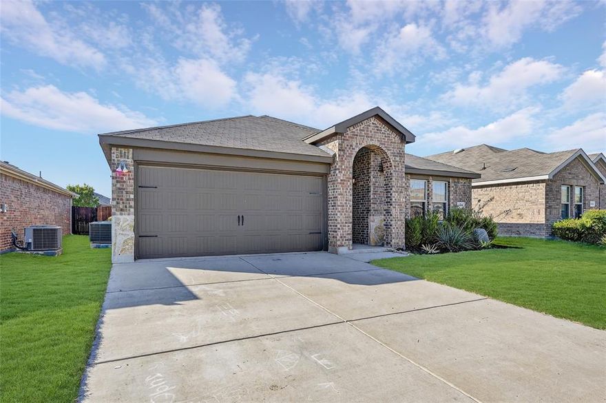 Beautiful one-story home in Sherman Crossing featuring great curb appeal and modern design touches. Inside, you’ll find luxury vinyl wood-like flooring throughout main areas and an open-concept layout that’s perfect for everyday living and entertaining. The stunning kitchen offers dark cabinetry, granite countertops, a subway tile backsplash, and a large island that opens seamlessly to the bright and airy living room with plenty of windows. The primary suite includes a glass-enclosed shower, extended countertop space, built-in shelving, and a spacious walk-in closet. Three additional bedrooms provide plenty of room for family, guests, or a home office. Enjoy the outdoors in the large backyard complete with a tall wood fence and a covered patio — perfect for relaxing or entertaining.