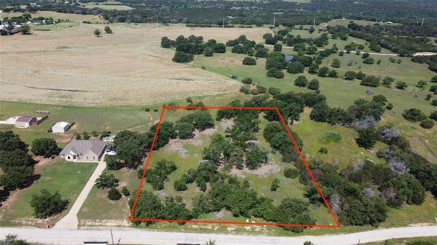 Enjoy the privacy offered by this stunning 2.24 acre lot outside city limits but close to Glen Rose. Great views, beautiful trees, and lots of space! One of the few remaining lots in highly desired Fossil Trails subdivision. Recently cleared and ready for you to build under the large hardwood oak trees. Plenty of room for a home, pool, barn and more. County water and electricity is available at the road. Property backs up to a large ranch for added privacy. 2,000 square foot minimum for build, no timeline to build, choose your builder. Located in highly acclaimed Glen Rose ISD, close to Fossil Rim Wildlife Center and Dinosaur Valley State Park.