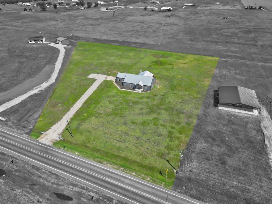 Looking for PEACEFUL COUNTRY LIVING yet minutes to TOWN? Look No Further! Imagine watching the Sunrise & Sunsets without the hustle and bustle around you! Sits on almost 3.5 ACRES! NO HOA! OUTSIDE CITY LIMITS! GREAT LOCATION with easy access to IH35 & Hwy 77*GREAT PLACE TO RUN YOUR BUSINESS OUT OF*SPACIOUS OPEN FLOOR PLAN BARDOMINIUM with all the right space*Concrete Stained Floors throughout for easy care maintenance*Outdoor FIREPLACE on the HUGE COVERED PATIO in the Back*ISLAND KITCHEN with stunning GRANITE Countertops, Barn Door Large Walk in Pantry, tons of Counterspace & Cabinets, BUILT IN REFRIGERATOR*Super Spacious Master Bedroom with a Sitting Area & access to the Back Covered Patio*SPA LIKE MASTER BATH with a TUB & SEPERATE SHOWER*Large Living Room with Windows overlooking the Acreage*Generous Secondary Bedrooms with a Living Room in-between to use as a Study, Living, Playroom or Gameroom*Sizable Laundry Room with CABINETS*Oversized Garage*Great property to add that Workshop or Pool that you always wanted*COME SEE!!
