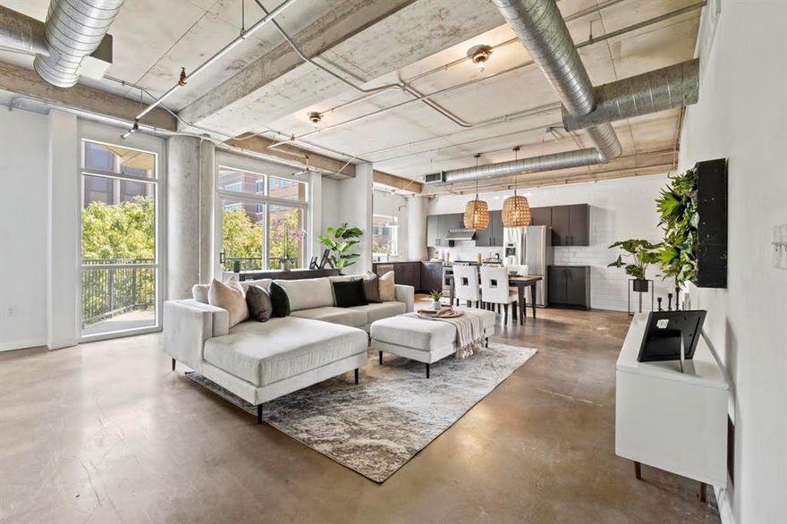 Beautiful condo in the vibrant South Side-Cedars neighborhood with floor-to-ceiling windows and large balconies for abundant light and outdoor living. The open floor plan connects living, dining, and a chef's kitchen with charcoal cabinetry, redwood countertops, subway tile accents, custom lighting, a pot rack, and premium KitchenAid appliances. Smooth concrete floors add a modern, low-maintenance style. Primary bath is updated with generous closets and full-size washer & dryer connections. Building offers controlled access, parking garage, turfed dog park, and an amenity level with pool, hot tub, grills, and outdoor lounge -- all framed by relaxing tree-top views.