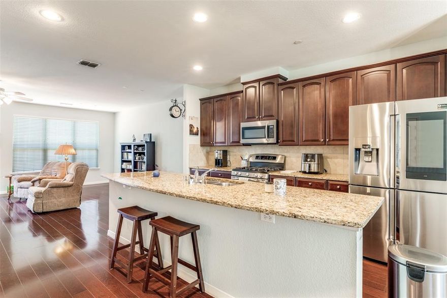 Welcome to 3888 Everwood Lane, a beautifully maintained three-story townhome in the highly sought-after Asbury Circle community in Addison. Built in 2008, this light-filled home offers 2,509 square feet, 4 bedrooms, 3 full baths, and 2 powder baths, with a flexible layout designed for both everyday living and entertaining.

The second-floor main living area features rich wood flooring, soaring ceilings, and an open-concept design that connects the living, dining, and kitchen spaces. The chef’s kitchen includes granite countertops, stainless steel appliances, a large island with breakfast bar seating, and ample cabinetry. Just off the living area, a private balcony provides the perfect spot for morning coffee or evening relaxation.

The third-floor primary suite offers a peaceful retreat with a spa-inspired bath featuring dual vanities, a soaking tub, separate shower, and a spacious walk-in closet. Two additional bedrooms, a full bath, and laundry complete the upper level. The first-floor bedroom with an ensuite bath provides excellent flexibility for guests, a home office, or a private workspace.

Recent updates include new HVAC units, fresh interior paint, and a new garage door motor and keypad, making the home move-in ready.

Enjoy low-maintenance townhome living with beautifully landscaped surroundings and easy access to Addison’s restaurants, shopping, and entertainment. Residents can also join the Addison Athletic Club for a one-time $10 fee, offering indoor and outdoor pools, a full fitness center, tennis and pickleball courts, trails, parks, and more.

Conveniently located near the Dallas North Tollway, President George Bush Turnpike, and I-635, this home combines comfort, convenience, and an exceptional Addison lifestyle.