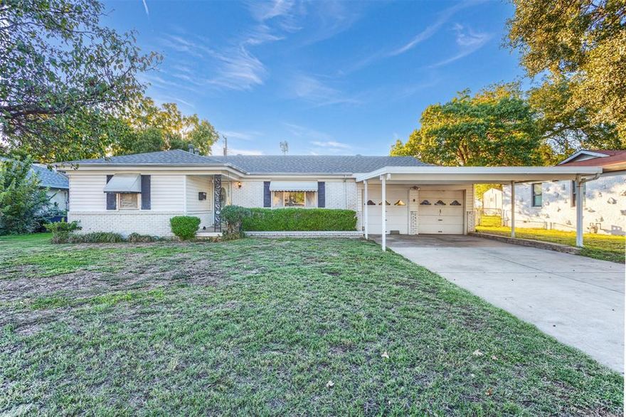 This home has possibilities! Could be the perfect investment or rental property, or with just a few updates, personalize this one and call it home!  Spacious front living area with entry to kitchen. Kitchen with breakfast bar adjoins additional living space (15' x 11'), perfect for dining or entertaining. Relax on the large, covered back porch overlooking backyard with beautiful mature trees. Sprinkler system makes maintaining gorgeous lawn easy. Garage, covered carport and two car driveway offer plenty of parking spaces. Workbench, cabinetry and additional garage area provide for hobbies and storage. New roof and carpet. 2 refrigerators for extra beverages, etc. and washer and dryer to convey. Convenient to Hurst, and easy access to Fort Worth, Arlington and Irving.
