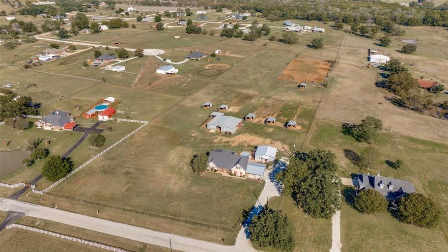 Your Own Piece of Paradise! This amazing 4 bed, 3 bath home with family room and den also boasts a beautiful
1 bed, 1 bath, with an office guest house with its own private courtyard and covered back porch! Main house
has large covered back porch with outdoor living center and a perfect place for your hot tub! Great kitchen
offers granite tops, newer appliances, stainless refrigerator, breakfast bar and custom cabinetry! Two large
living areas downstairs, one with a cozy fireplace, and the 4th bedroom and bath upstairs. A few steps out the
back door and you are in the 6 stall horse barn, 4 stalls with runs, 2 box stalls. Separate room for tack and feed
with plenty of room for hay storage. Implement shed behind the barn and covered dog run on the side of the
barn. 6 large loafing sheds each with its own paddock, plenty of pasture and a lit roping arena, fully fenced
with returns and a chute. This place has it all and is affordably priced! Come see it today!