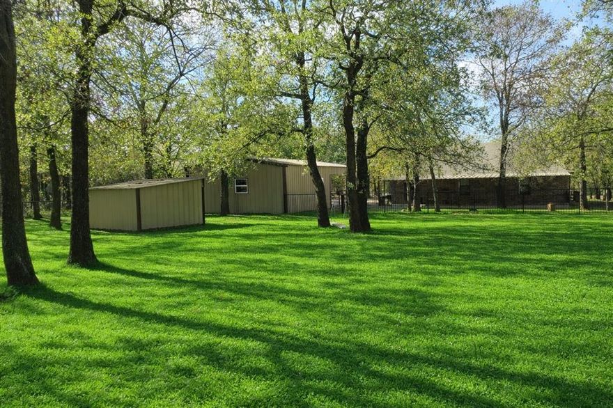 Seller is offering a $10,000 credit to buyer to use at their discretion.  Discover a secluded rural oasis in this solid brick ranch type home nestled on a sprawling, tree-lined acreage. The interior features an expansive open-concept great room with modern recessed lighting and a stunning custom-built knotty pine entertainment center. This inviting space flows into a bright dining nook and a highly efficient galley-style kitchen with abundant custom cabinetry.

The property is a true hobbyist’s dream, boasting a massive detached metal shop with partitioned storage, high ceilings, and a generous covered carport. Outdoor living is exceptional, featuring a full-length covered rear patio overlooking a level, fully fenced backyard. With secondary storage sheds and accessible ramp entry, this peaceful retreat offers versatility and comfort in a private setting.

Information deemed reliable but not guaranteed. Buyer and buyer’s agent to verify all details. Some photos have been virtually enhanced for presentation purposes.