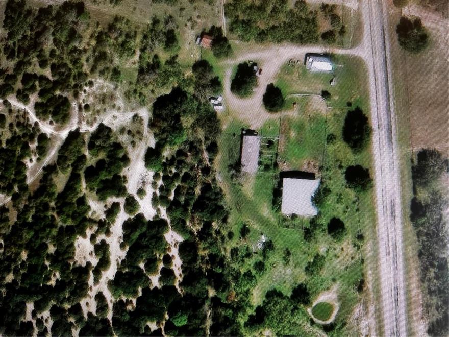 6.63 acres with barn, pens, arena and an older home, currently used as a rental.